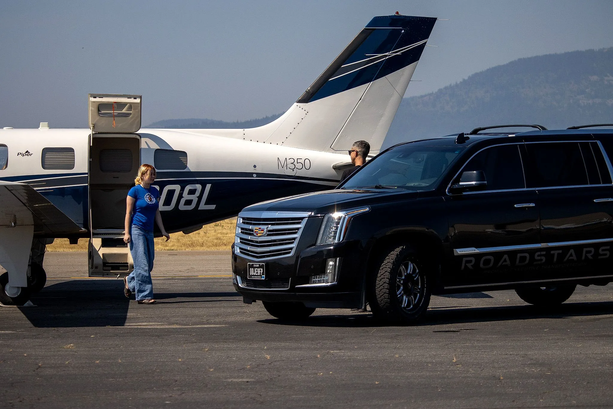 A guest stepping off a Piper M350 to the waiting RoadStars Escalade at Coeur d’Alene Airport