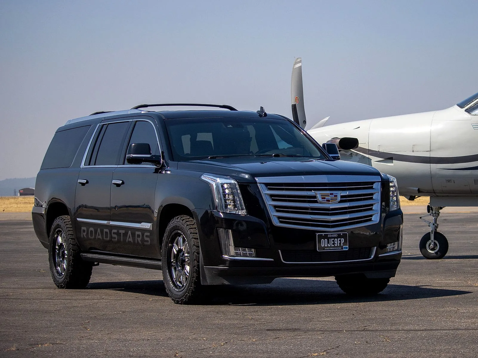 The RoadStars Cadillac Escalade ESV on the ramp at Coeur d’Alene Airport, a Pilatus PC-12 behind it