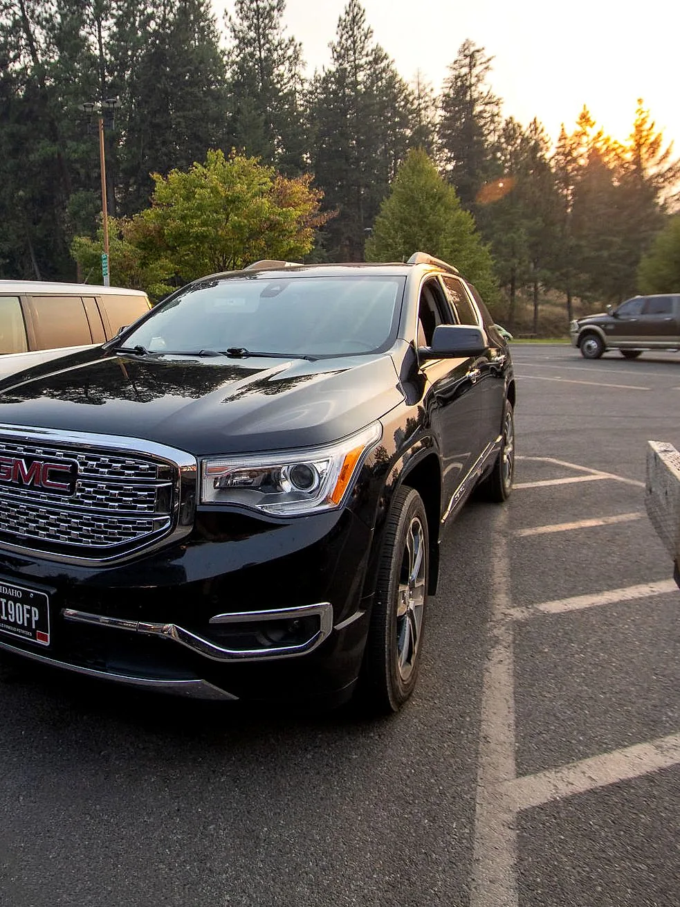 The RoadStars GMC Acadia Denali in late afternoon sunlight beneath North Idaho pines